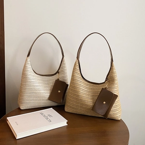 Handwoven straw hobo tote bags with brown leather straps and small hanging pouches
