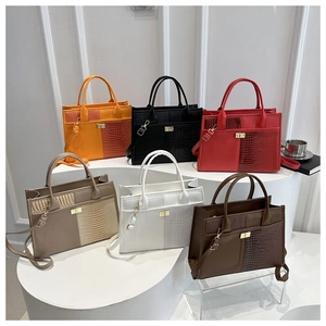 Collection of croc-pattern patchwork tote bags in six colors with gold twist locks