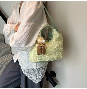 Detail of light green bubble texture tote bag with cute bear charm and shoulder strap