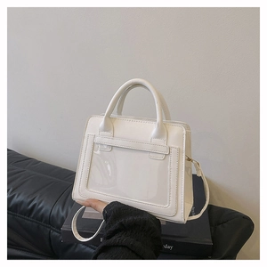 Detail view of white matte leather crossbody bag with transparent window and handle