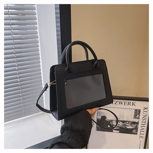 Detail of black PU leather crossbody bag with clear display pocket and gold hardware