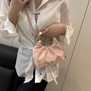Pink drawstring bucket bag with pearl beaded handle and cute bear print for women