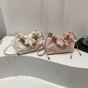 Fashionable pleated bucket bags with amber resin beads in cream and pink colors
