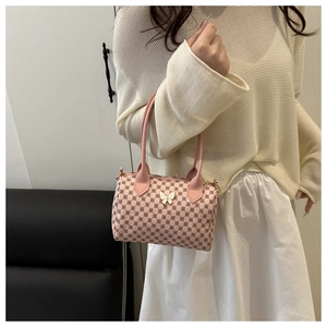 Detail of pink Boston bag with vintage monogram texture and white butterfly accessory