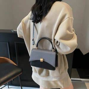 Chic black and grey textured crossbody bag with gold square lock and leather handle