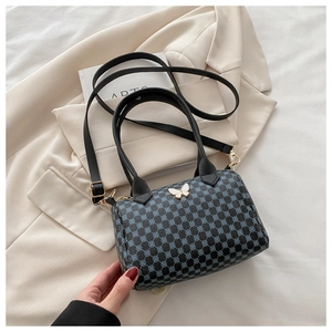 Close-up of Boston handbag with vintage floral print and white butterfly metal buckle