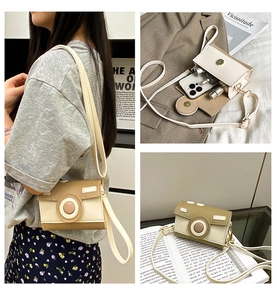 Macro detail of a camera-shaped crossbody phone bag showing interior space and magnetic flap