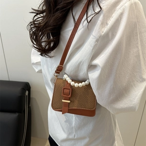 Brown woven crossbody bag with pearl handle and leather strap for women