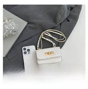 Detail of white woven mini square bag with gold chain and phone for size reference
