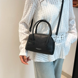 Chic black litchi leather doctor bag with top handles and adjustable shoulder strap