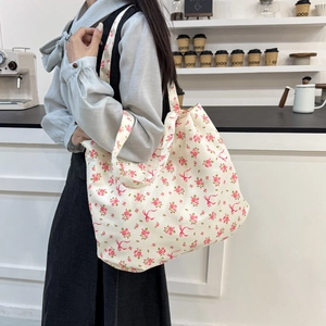 Floral canvas tote bag with pink bows, large capacity shoulder bag shown on model