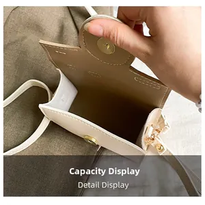 Detailed interior of a cream white mini crossbody bag showing magnetic snap and capacity