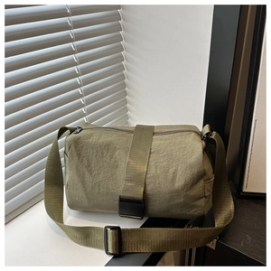 Detailed view of olive green oxford nylon travel bag with adjustable strap and buckle
