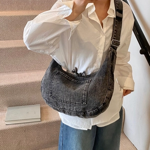 Minimalist dark gray washed denim crescent crossbody bag with adjustable strap and pocket