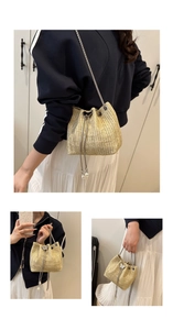 Detailed views of a straw bucket bag with silver chain strap and pearl drawstring closure