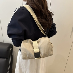 Minimalist beige oxford fabric crossbody bag for sports and travel shown on model back