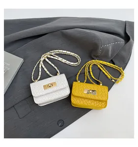 Detail of mini woven leather flap bags in white and yellow with metal turn-lock closure