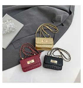 Detailed view of woven leather mini crossbody bags with gold metal rotating locks and chains