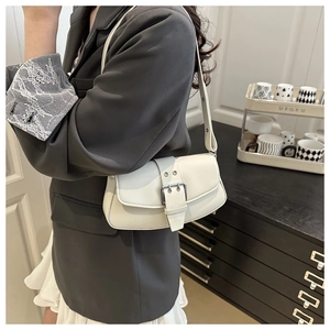 Detailed side view of white leather shoulder bag with vintage buckle and rectangular shape