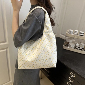 Floral canvas tote bag for women featuring yellow flower patterns and wide shoulder straps