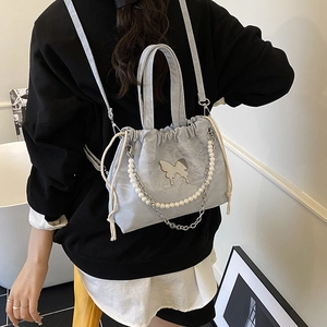 Light blue ruched backpack with pearl chain and silver butterfly charm in soft texture