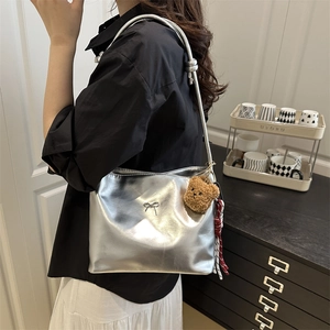 Silver metallic shoulder bucket bag with bow detail and bear charm for summer