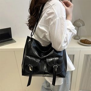 Glossy black large tote bag with front pockets for chic daily commuting fashion