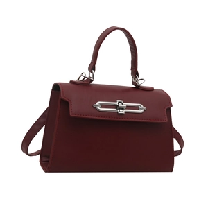 Minimalist burgundy crossbody handbag with matte finish and silver metal buckle