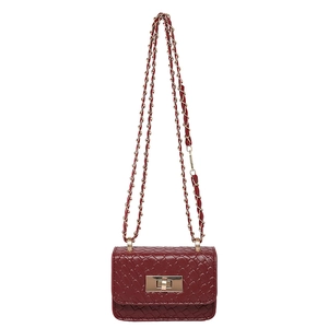 Retro burgundy woven crossbody bag with gold chain strap and metallic lock closure