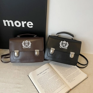 Sacoche style collège vintage avec blason, disponible en marron et noir