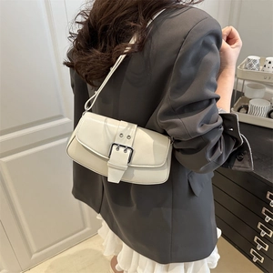 Minimalist beige faux leather shoulder bag with a large silver buckle and slim strap
