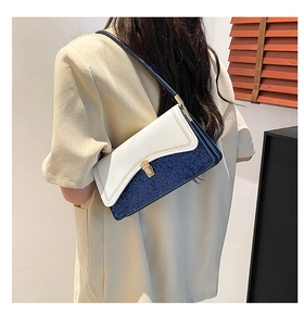 Detail of sequin shoulder bag with golden metallic lock and wavy contrast stitching