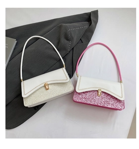 Close-up of glitter-panel shoulder bag with wave stitching and gold turn-lock closure