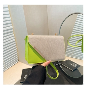 Detail of color-block flap bag with neon green leather and metallic bar accent