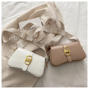 Detail of elegant shoulder bags with wide geometric jacquard straps in cream and coffee colors
