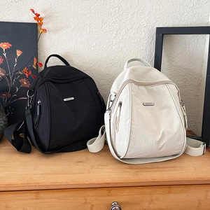 Large capacity nylon backpack for women in black and cream featuring lightweight water-resistant fabric