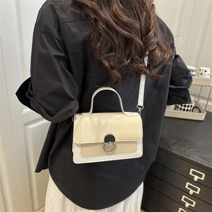 Chic woven beige and white leather crossbody bag with silver buckle and top handle