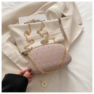 Detail of light pink evening bag with gold metal frame and sparkling rhinestone lock