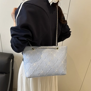 Quilted light blue tote bag with floral embroidery and gold chain strap for women