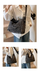 Detail of black denim crossbody bag featuring functional pockets and vintage washed texture