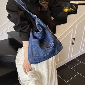 Retro denim hobo shoulder bag with large capacity and contrast stitching worn by model