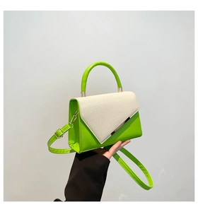 Detail of contrast stitch handbag with neon green PU and white woven texture flap