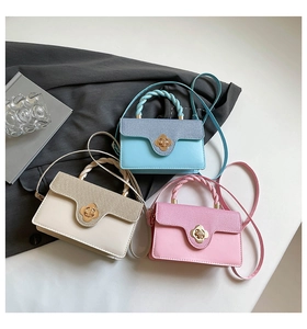 Detailed view of three pastel mini crossbody bags with gold floral clasps and braided handles