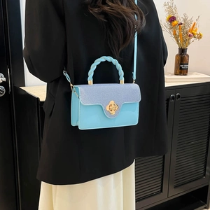 Minimalist light blue crossbody bag with braided handle and golden flower twist lock