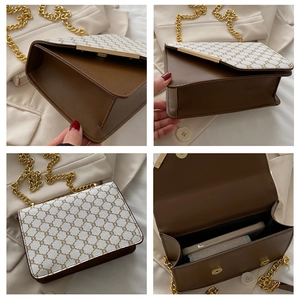 Detail view of small square shoulder bag with brown leather and gold chain strap