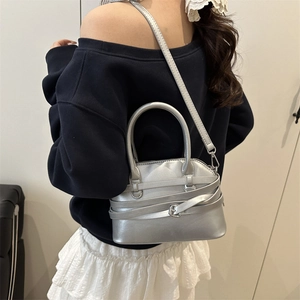 Silver metallic minimalist shell bag with decorative straps and silver buckle for women