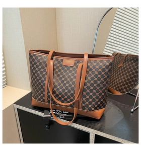 Close-up of vintage monogram pattern and leather patch on the brown tote shoulder bag
