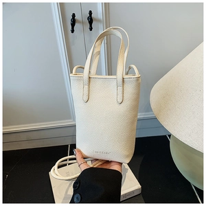 Close-up of cream white lychee texture leather mini tote bag with sweet color embossed logo