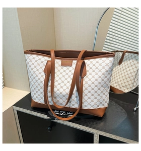 Detail of vintage monogram canvas tote with premium brown leather trim and shoulder strap