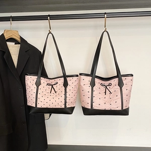 Pink heart and bow tote bag with black trim and long straps for casual summer style